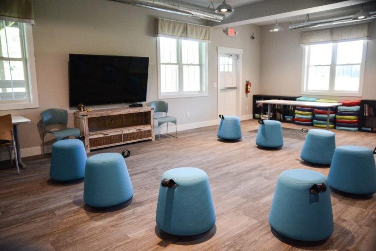 gathering area with modern stools and tv